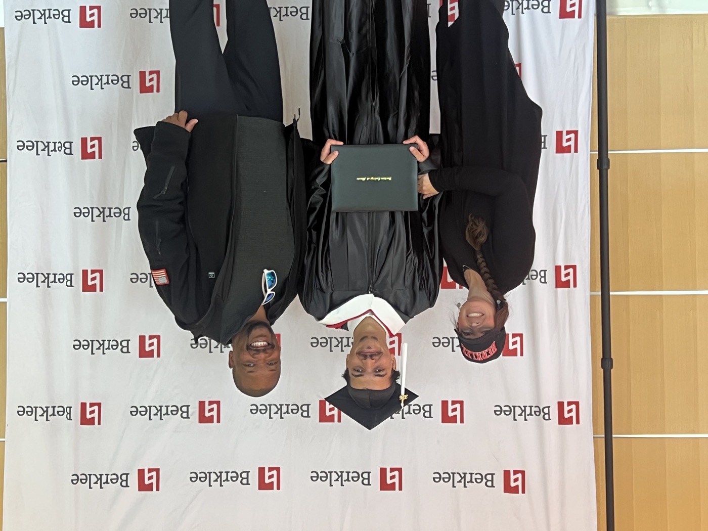 Isaiah Briggs at Berklee commencement, May 2026, holding his diploma with his parents